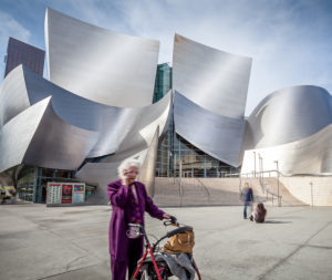 Walt Disney Concert Hall, Los Angeles, senior with walking aid in the foreground Walt Disney Concert Hall, Los Angeles, senior with walking aid in the foreground